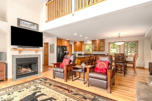 Smart TV, fireplace, books, computer monitors