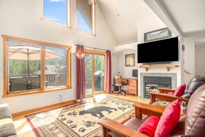 Smart TV, fireplace, books, computer monitors