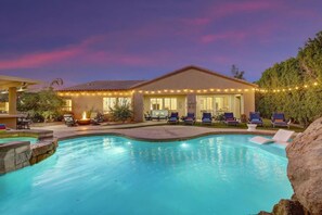 A swimming pool with lounge chairs, a covered patio, and string lights. - Echelon: Pool, Spa, Pool Table, Ping Pong table! (Indio)
