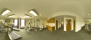 A gym with treadmills, elliptical machines, and weight equipment.