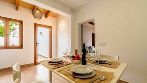 A dining area with a table set for four, including plates, cutlery, and wine glasses. - Wonderful private villa for 6 people with WIFI, A/C, TV and patio (Andratx)