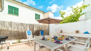 An outdoor dining area with a table set for breakfast, a grill, and a view of the surrounding buildings. - Wonderful private villa for 6 people with WIFI, A/C, TV and patio (Andratx)