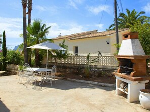 Enjoy al fresco dining on the patio with a barbecue grill and comfortable seating for four.