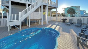 A two-story building with a pool, outdoor seating, and a covered deck area. - 5 bedrooms, 4 bathrooms,  2nd Row Home w/ Heated Pool! (Supply)