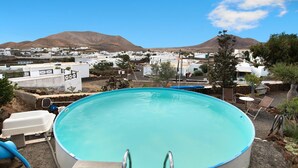 A swimming pool with a view of a town and mountains in the background. - Holiday Home Casa Consultorio with Mountain View, Pool, Wi-Fi & Terrace (GUATIZA)