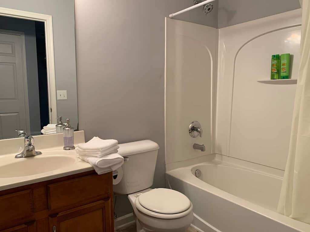 A bathroom with a sink, toilet, and bathtub.