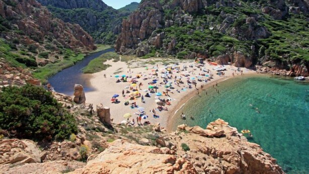 A coastal beach with rocky cliffs and clear waters. - Vacation home Cisto by Interhome (Costa Paradiso)