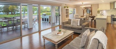 A spacious living room with a large sliding glass door leading to an outdoor patio area.