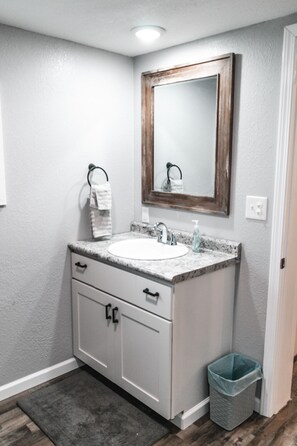Combined shower/bathtub, hair dryer, towels, toilet paper