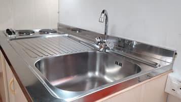 Fridge, stovetop, cookware/dishes/utensils, dining tables