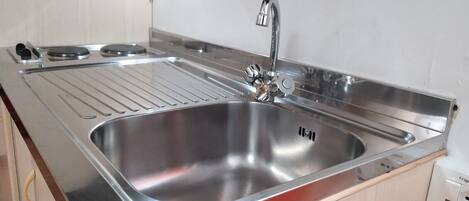 Fridge, stovetop, cookware/dishes/utensils, dining tables