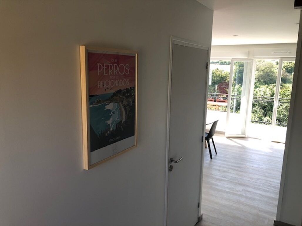 A room with a door leading to a balcony.