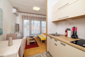 Apartment (A4) | Private kitchen | Fridge, stovetop, electric kettle, cookware/dishes/utensils - Apartments Zec (Crikvenica)