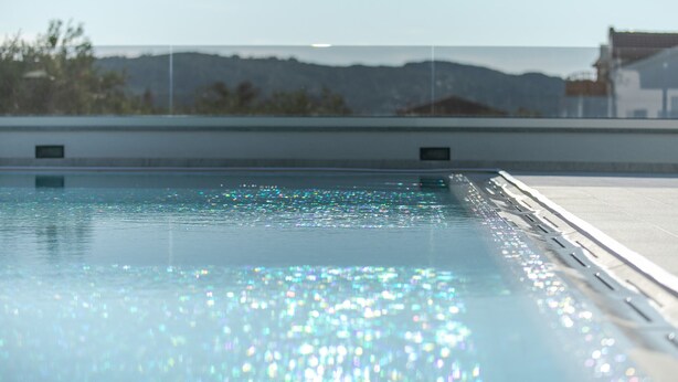 A swimming pool with a clear view of the surrounding landscape. - Apartments Dora (Okrug Gornji)