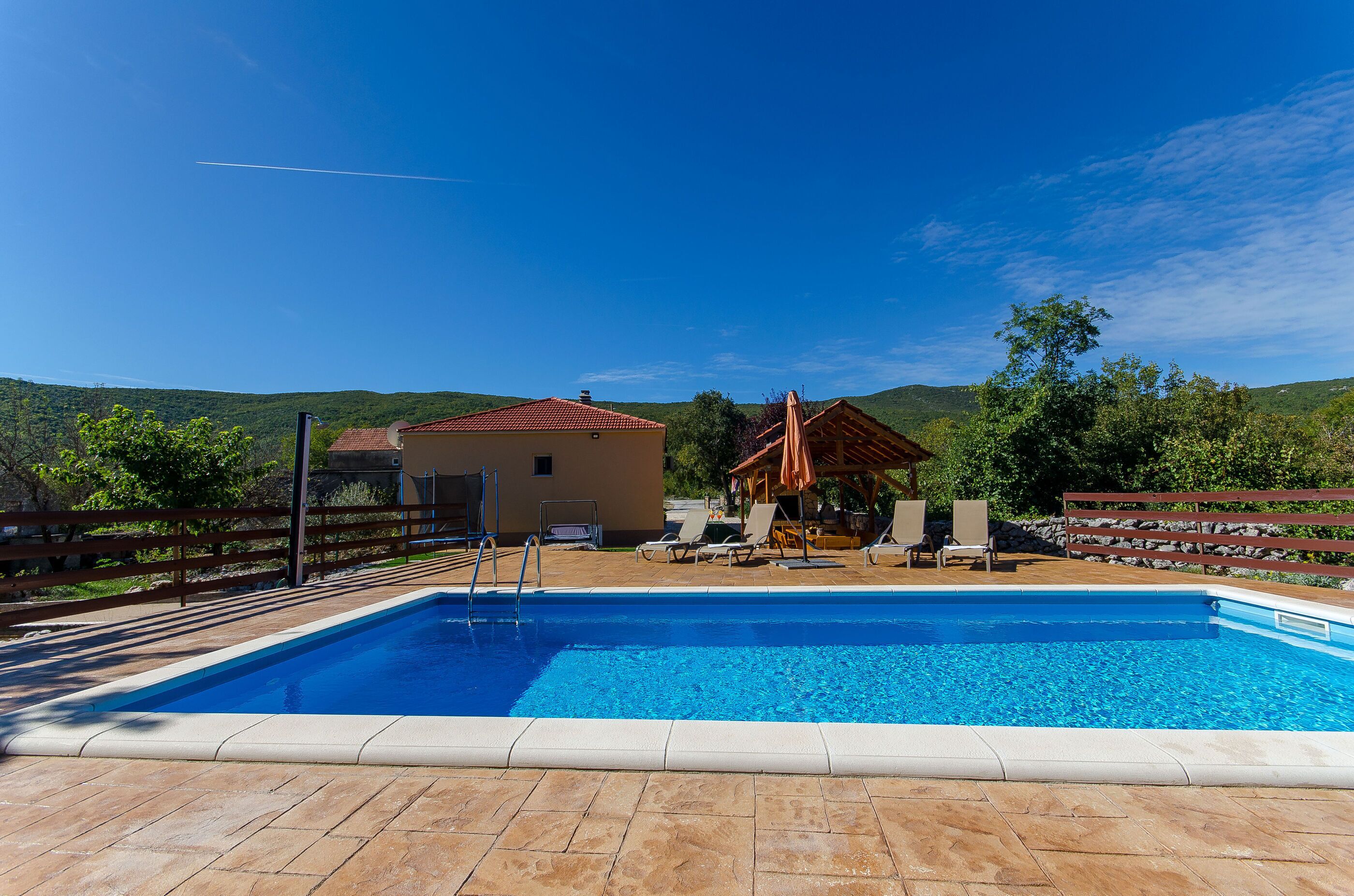 Outdoor pool, a heated pool, open open 24 hours a day, pool umbrellas