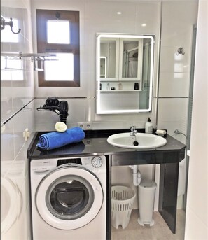 Chuveiro, secador de cabelo, toalhas de banho, shampoo