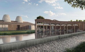 A modern building with a pool, outdoor seating, and two large stone structures. - Aramness Gir National Park (Mendarda)