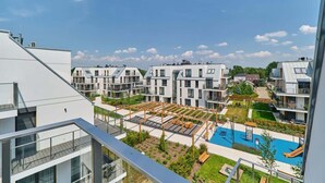 A residential building with a rooftop garden, a swimming pool, and a playground.