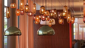 Un intérieur moderne agrémenté de plusieurs suspensions et d’un grand miroir.