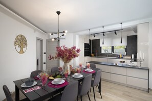 A modern kitchen with a dining area.