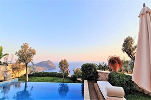An infinity pool, pool loungers