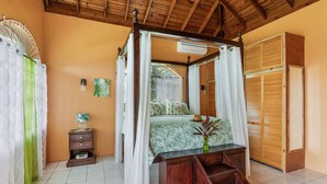 A four-poster bed with a canopy, a wooden wardrobe, and a small bedside table with a vase. - YanceyLargo- 4BR Villa Jacuzzi & Mountain Views by RedAwning (Montego Bay)