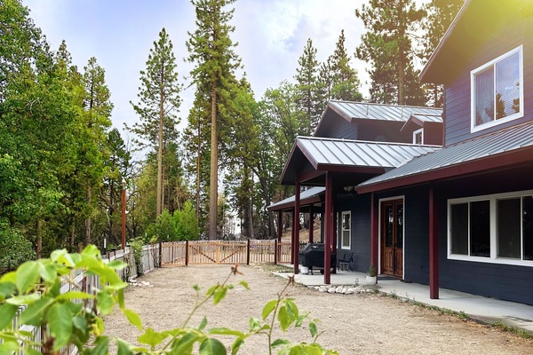 Front of cabin with view of the backyard and dog run