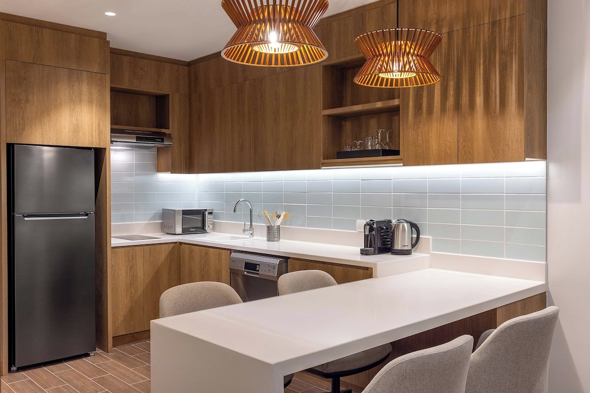 desk, laptop workspace, iron/ironing board, bed sheets