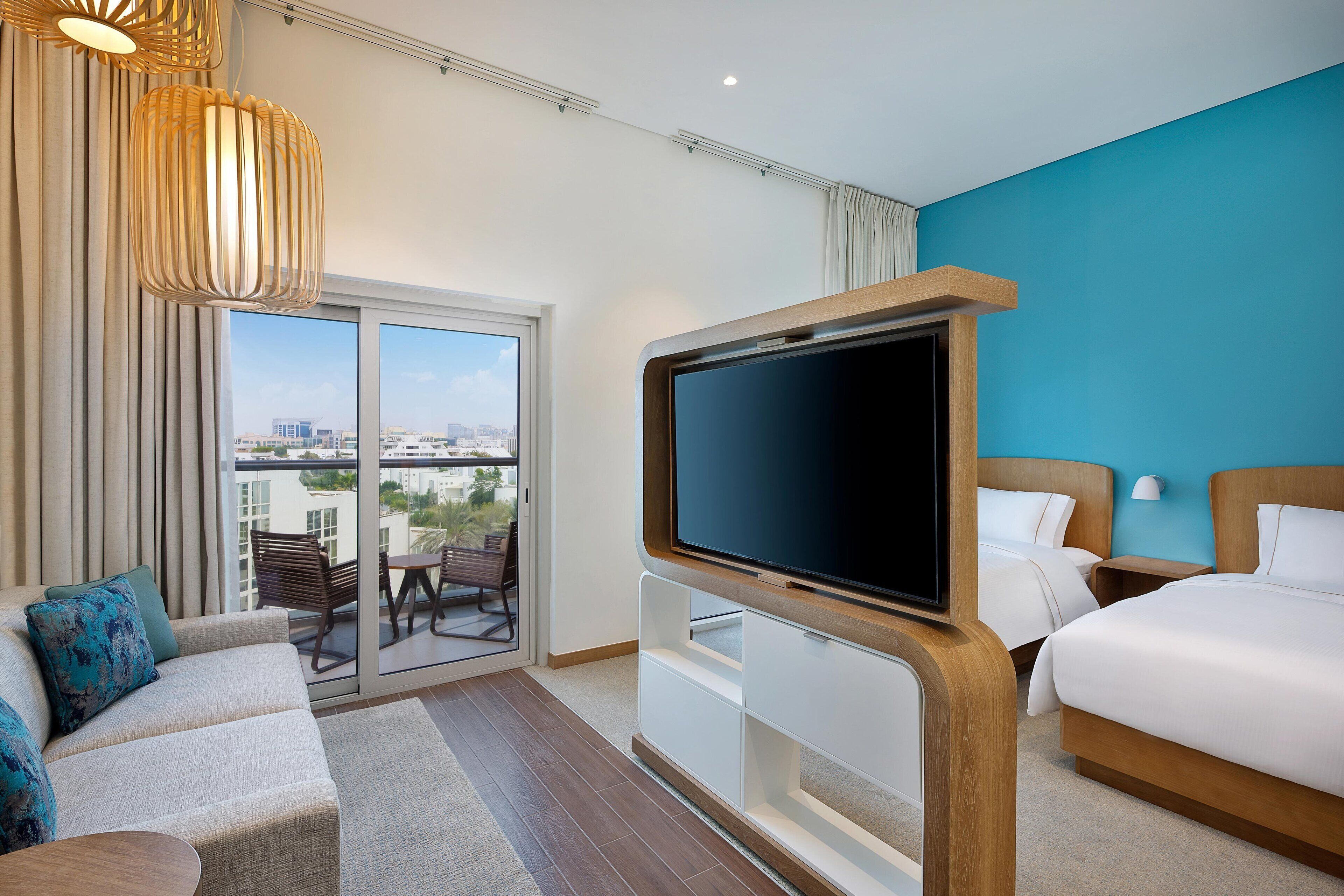 desk, laptop workspace, iron/ironing board, bed sheets