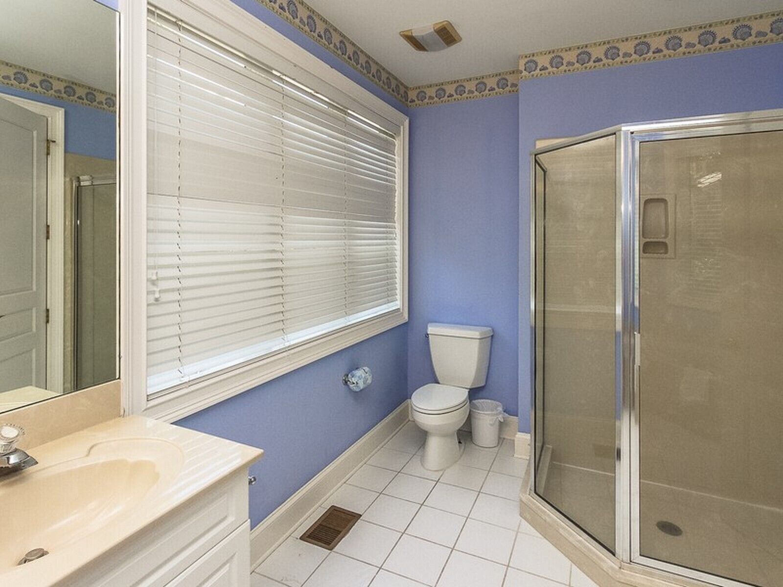 A bathroom with a toilet, sink, and shower.