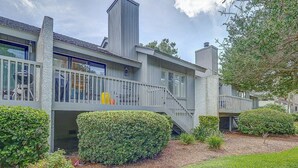 A modern two-story house with a balcony, a chimney, and a well-maintained garden. - 3BR Villa w/ Just a 2 Minute Walk from Beach (Hilton Head Island)