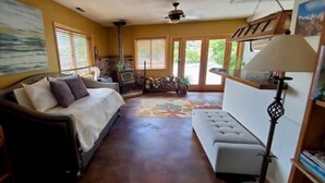 A cozy living room with a sofa, a coffee table, a fireplace, and a large window. - ***Million Dollar Views and Indoor Pool! (Lone Pine)