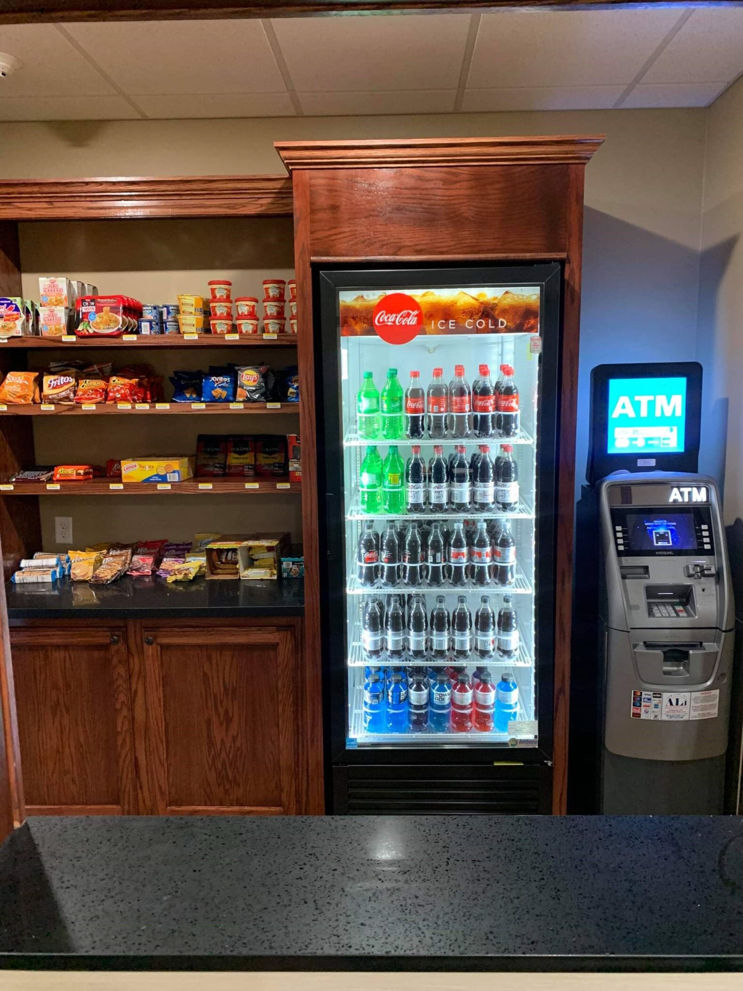 A vending machine with snacks and a Coca-Cola refrigerator.