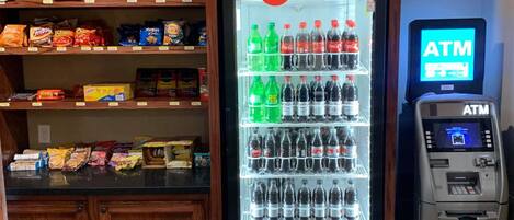 A vending machine with snacks and a Coca-Cola refrigerator.