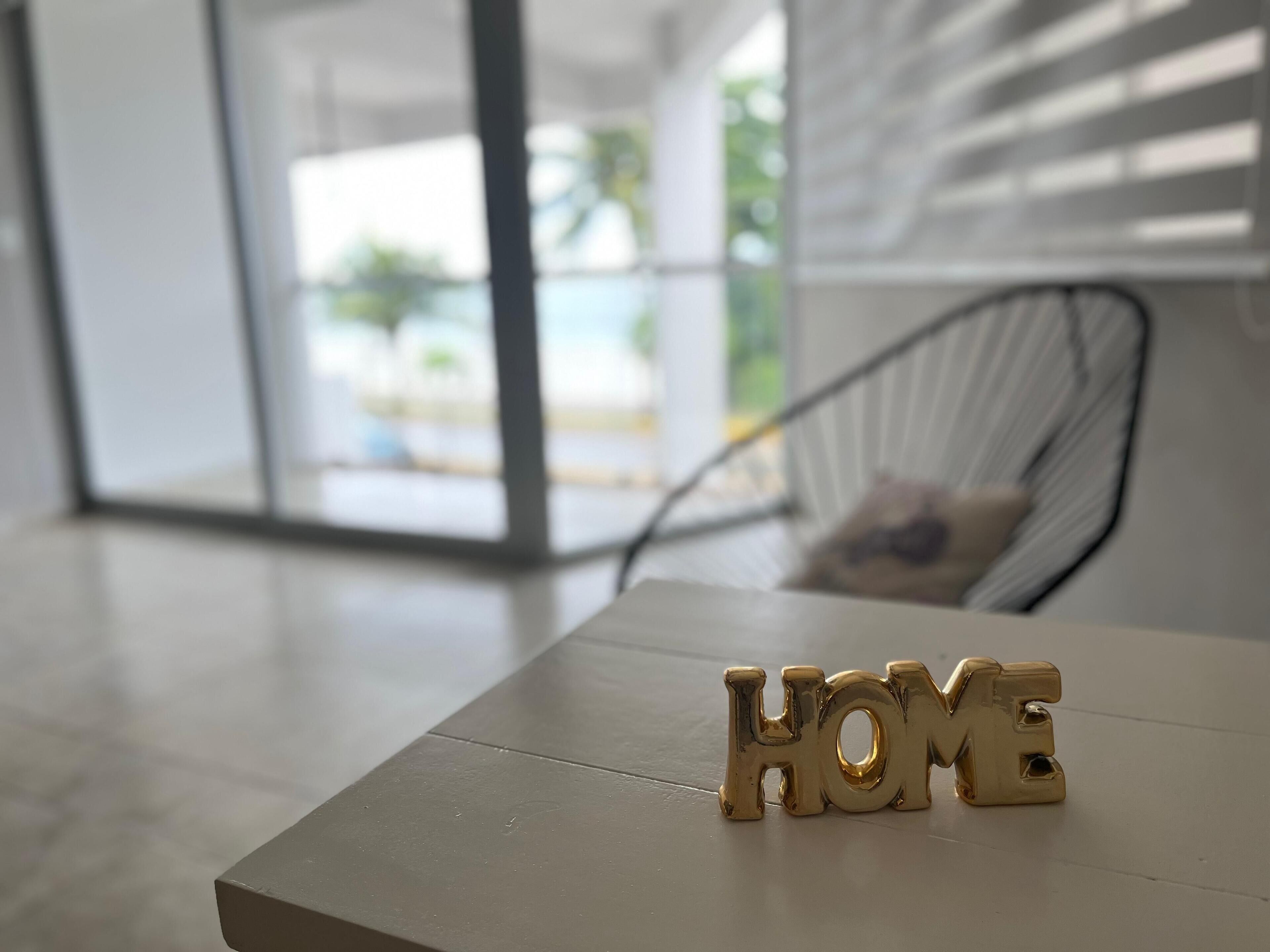 A table with the word "HOME" spelled out in gold letters.