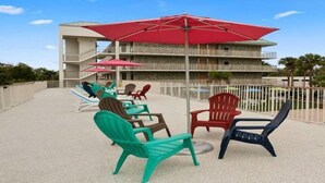 A rooftop patio with outdoor seating and a pool.