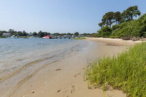 Enjoy serene beach views and access to a wooden pier for water activities.