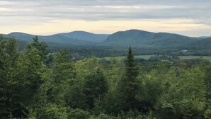 A mountainous landscape with dense forest and power lines. - Ski Retreat with scenic mountian and river views  (Hanover)