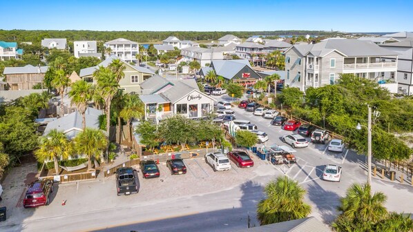 A coastal town with a variety of buildings, including a restaurant named 'Chirivisa'.