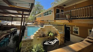A pool area with outdoor seating and a covered patio. - Haggville Hacienda - Private Riverfront @Vacation Frio River - Pool Sleeps 29-38 (Concan)