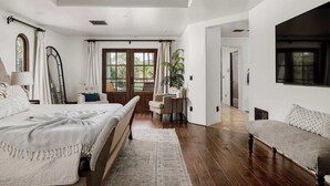 A bedroom with a bed, a desk, a chair, a sofa, and a window with curtains. - ParadiseValleyMillion$ Estate+Golf+Boccee+Casita (Paradise Valley)