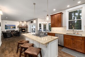 Enjoy cooking in this kitchen with a large island, gas stove, and ample counter space.