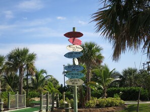 A directional signpost with destinations and distances. -  NAUTICAL-THEMED CONDO OCEANFRONT COMPLEX STEPS TO THE BEACH ACCESS, HEATED POOL (Cocoa Beach)