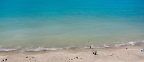 On the beach, sun-loungers, beach towels