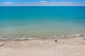 On the beach, sun-loungers, beach towels -  NAUTICAL-THEMED CONDO OCEANFRONT COMPLEX STEPS TO THE BEACH ACCESS, HEATED POOL (Cocoa Beach)