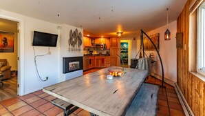 A modern kitchen with wooden cabinets, a built-in microwave, and a fireplace.