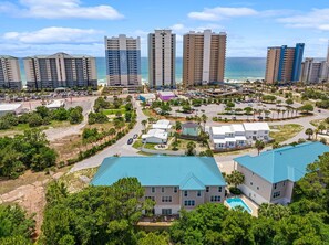A coastal resort area with high-rise hotels, a parking lot, and a swimming pool. - Unwind Your Mind...5 BR,4.5 baths...Book now for Summer (Panama City Beach)