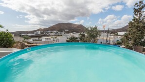 A swimming pool with a view of a town and mountains in the background. - Holiday Home Casa Cueva with Mountain View, Pool, Wi-Fi & Terrace (Guatiza)
