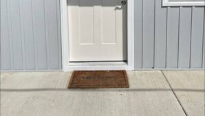 A white single-story building with a front door, a small window, and a mailbox. - GOTL Strip Suite #3- Sunset Vacation Rentals (Geneva)