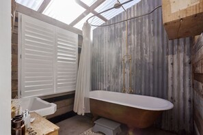 Combined shower/bathtub, towels, soap, toilet paper